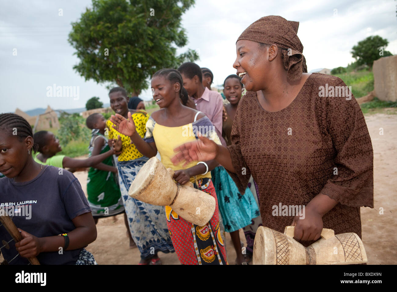 Adolescent girls sing and dance together at an after school program in Dodoma, Tanzania, East Africa. Stock Photo