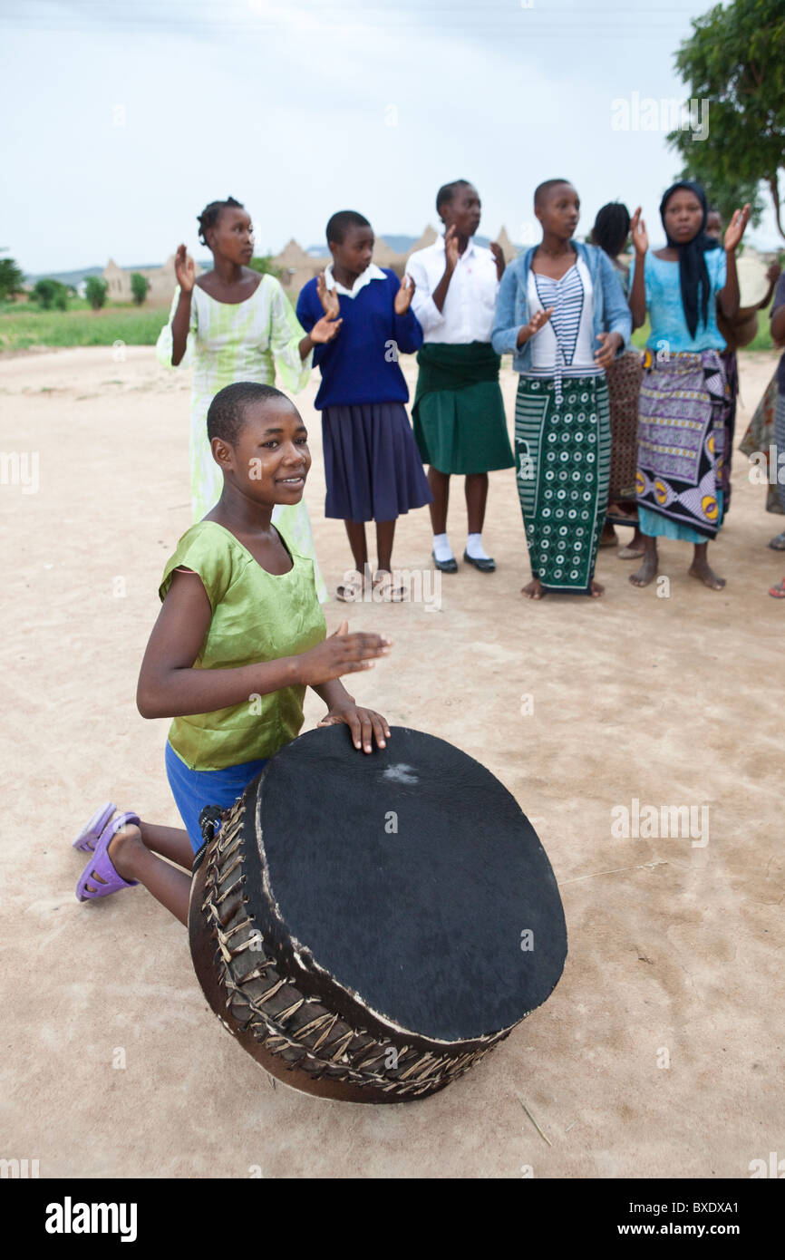 Adolescent girls sing and dance together at an after school program in Dodoma, Tanzania, East Africa. Stock Photo