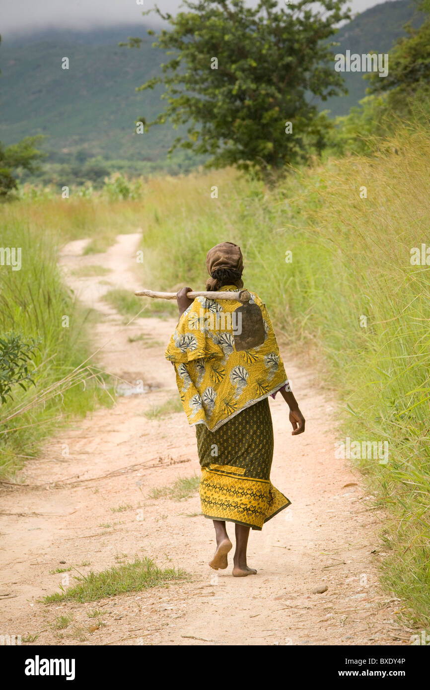 A farmer walks down a village lane outside Iringa, Tanzania, East Africa. Stock Photo