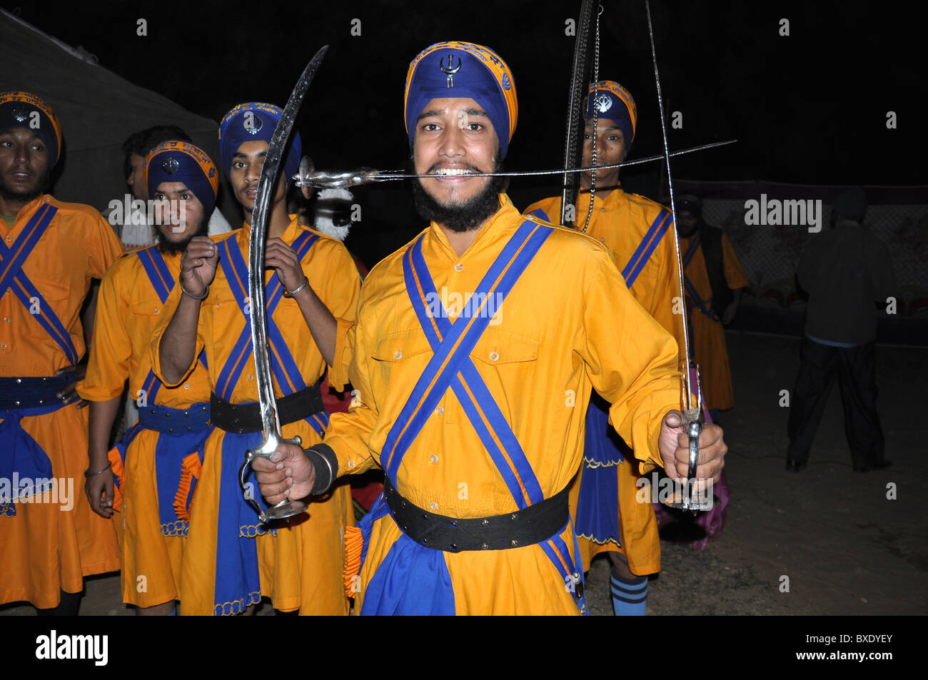 A group of sikhs performing on stage Stock Photo