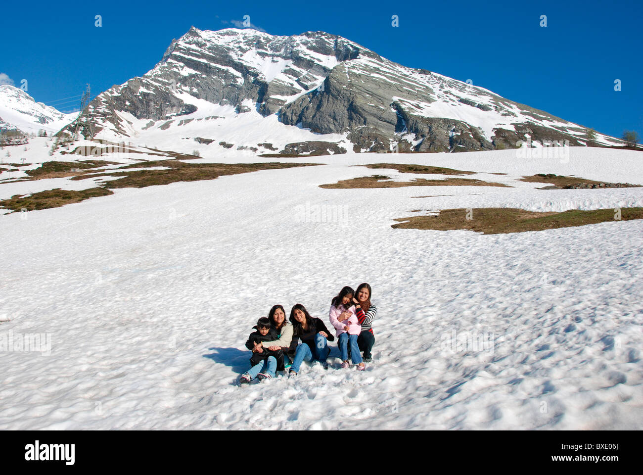 Indian family on vacation to the snow laden hills of Switzerland Stock Photo