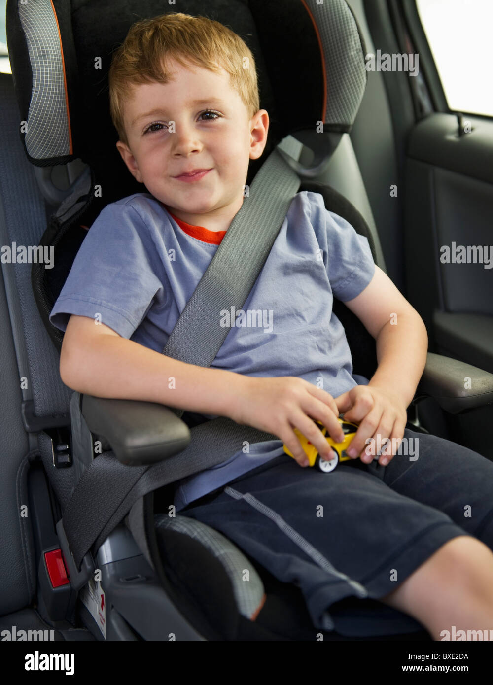 Young boy sitting in his car seat Stock Photo Alamy