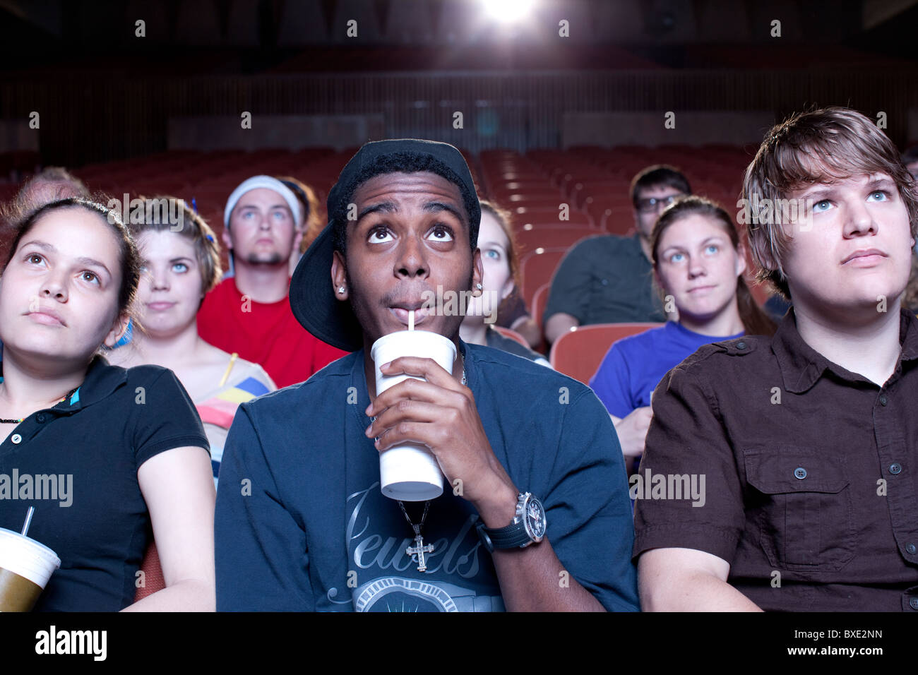 Friends watching movie in theater Stock Photo
