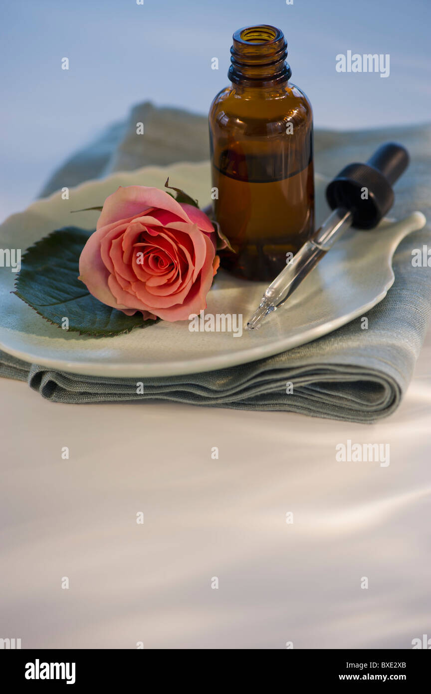 Essential oil and rose on tray Stock Photo