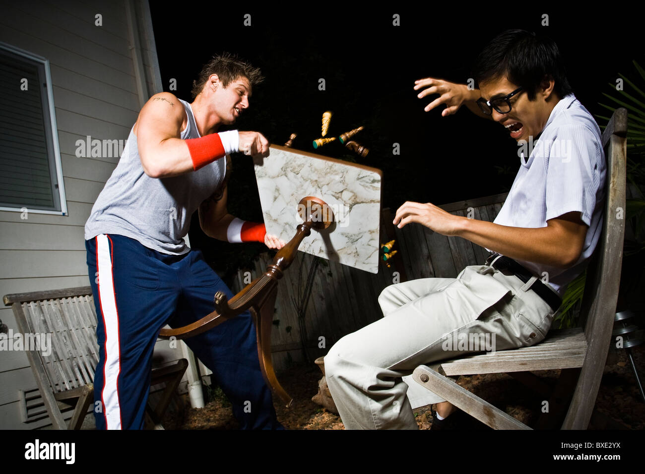 Body builder upsetting chess table Stock Photo