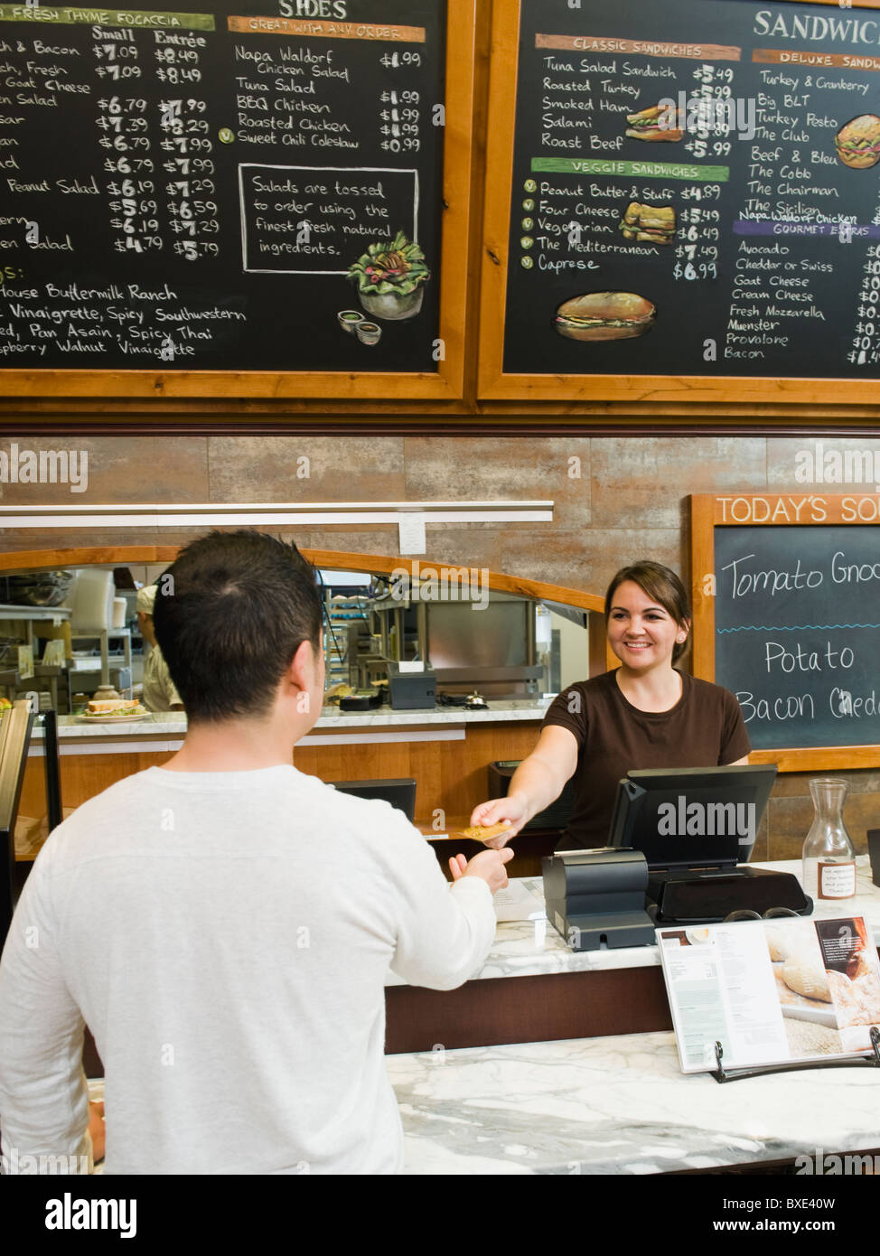 Customer paying for his bakery order Stock Photo Alamy