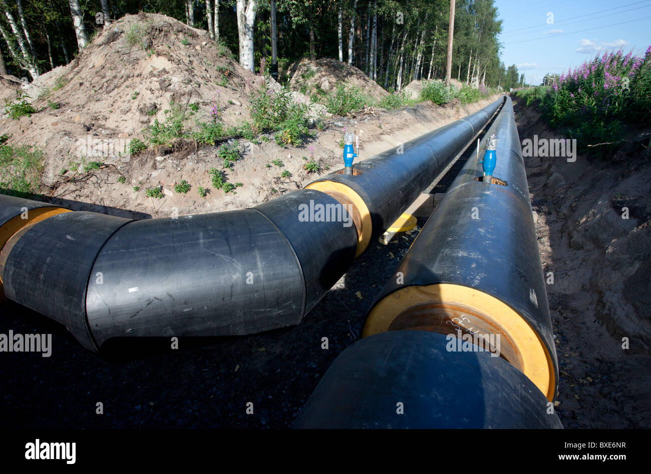 Pipe laying of underground district heating pipeline under construction , Finland Stock Photo