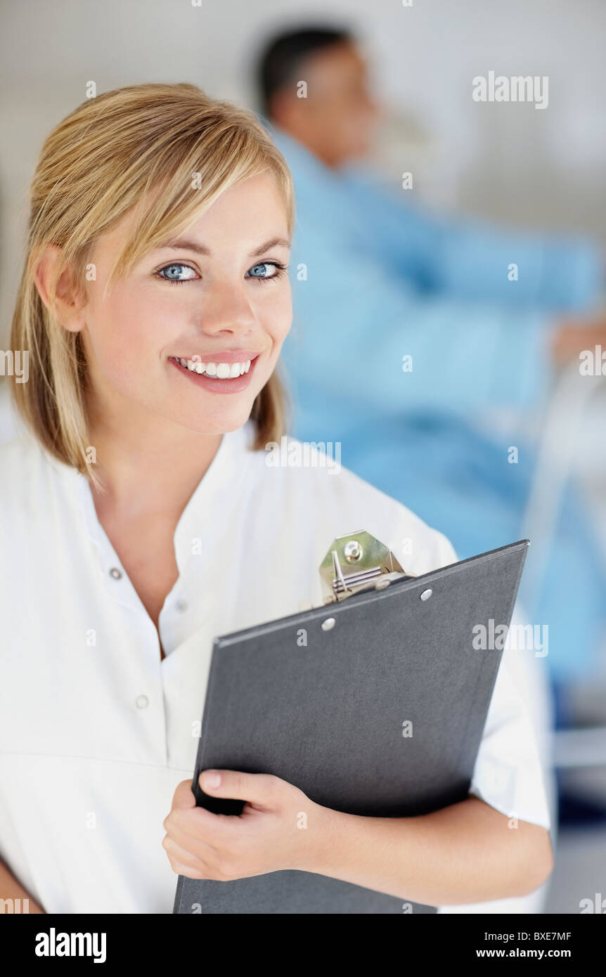 Nurse holding a clipboard Stock Photo - Alamy
