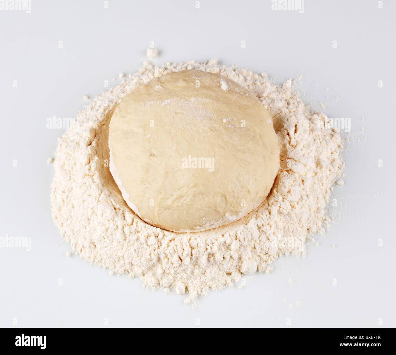 Raw pizza dough in flour Stock Photo Alamy
