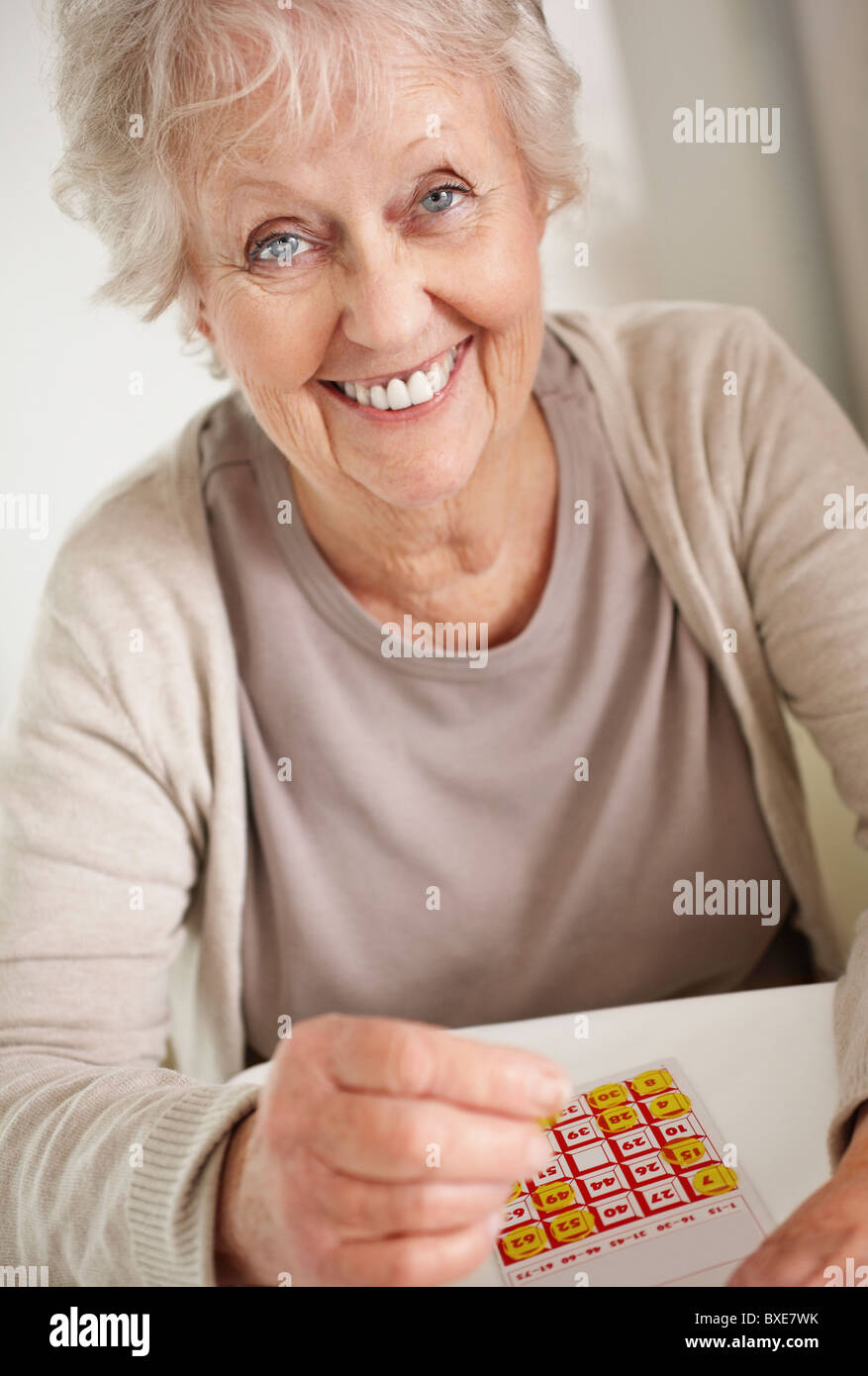 Senior woman playing bingo Stock Photo