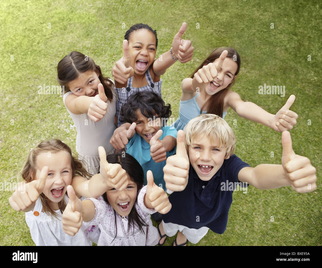 Group of children with their thumbs up Stock Photo - Alamy