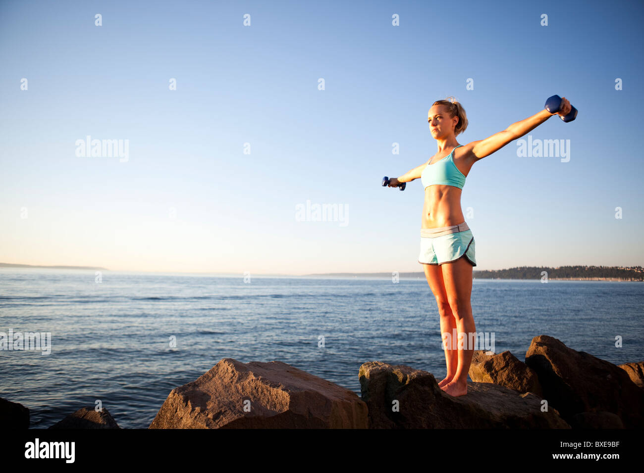 Athletic woman lifting weights outdoors Stock Photo Alamy