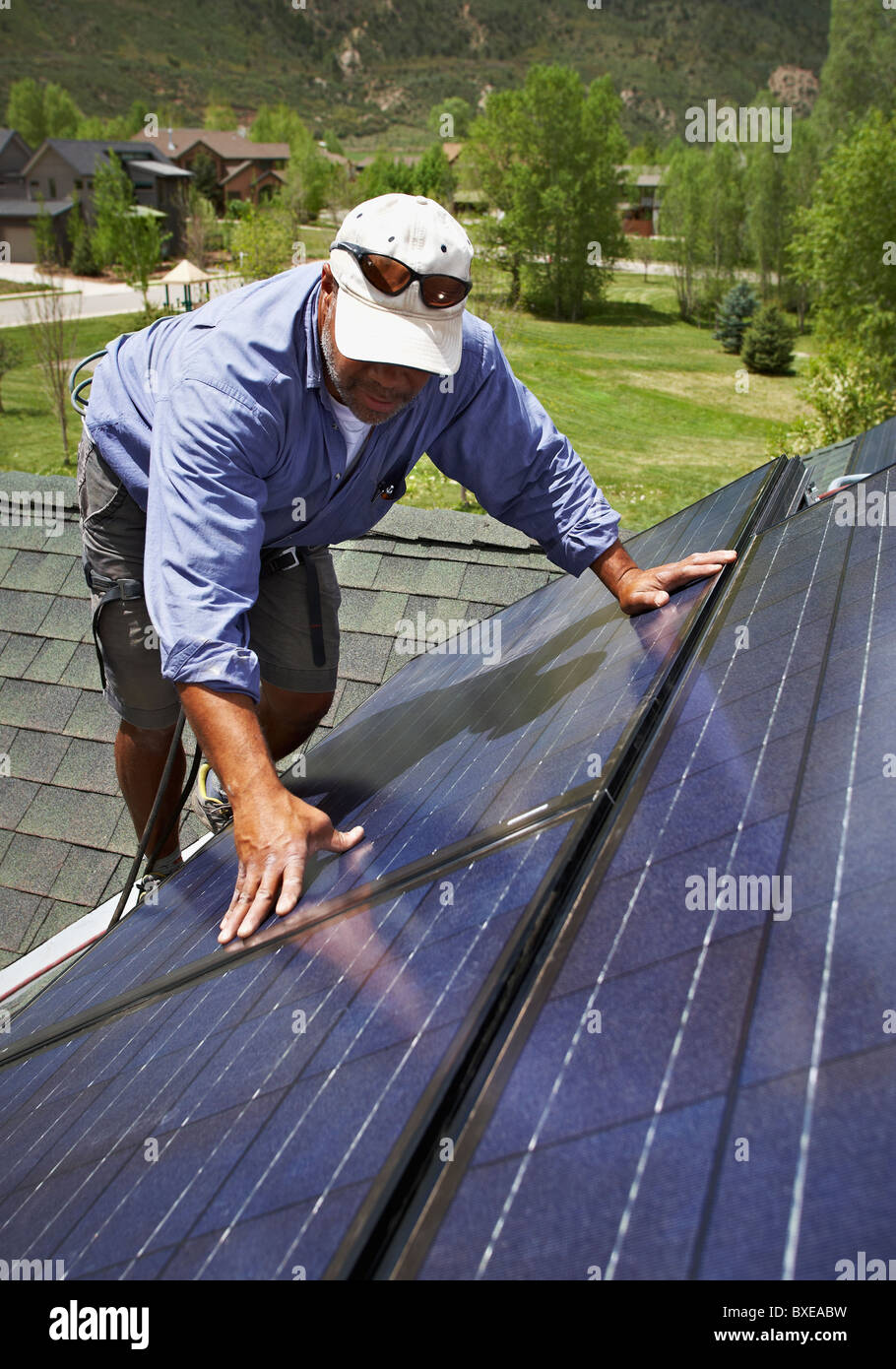 Construction worker installing solar panel on roof Stock Photo Alamy