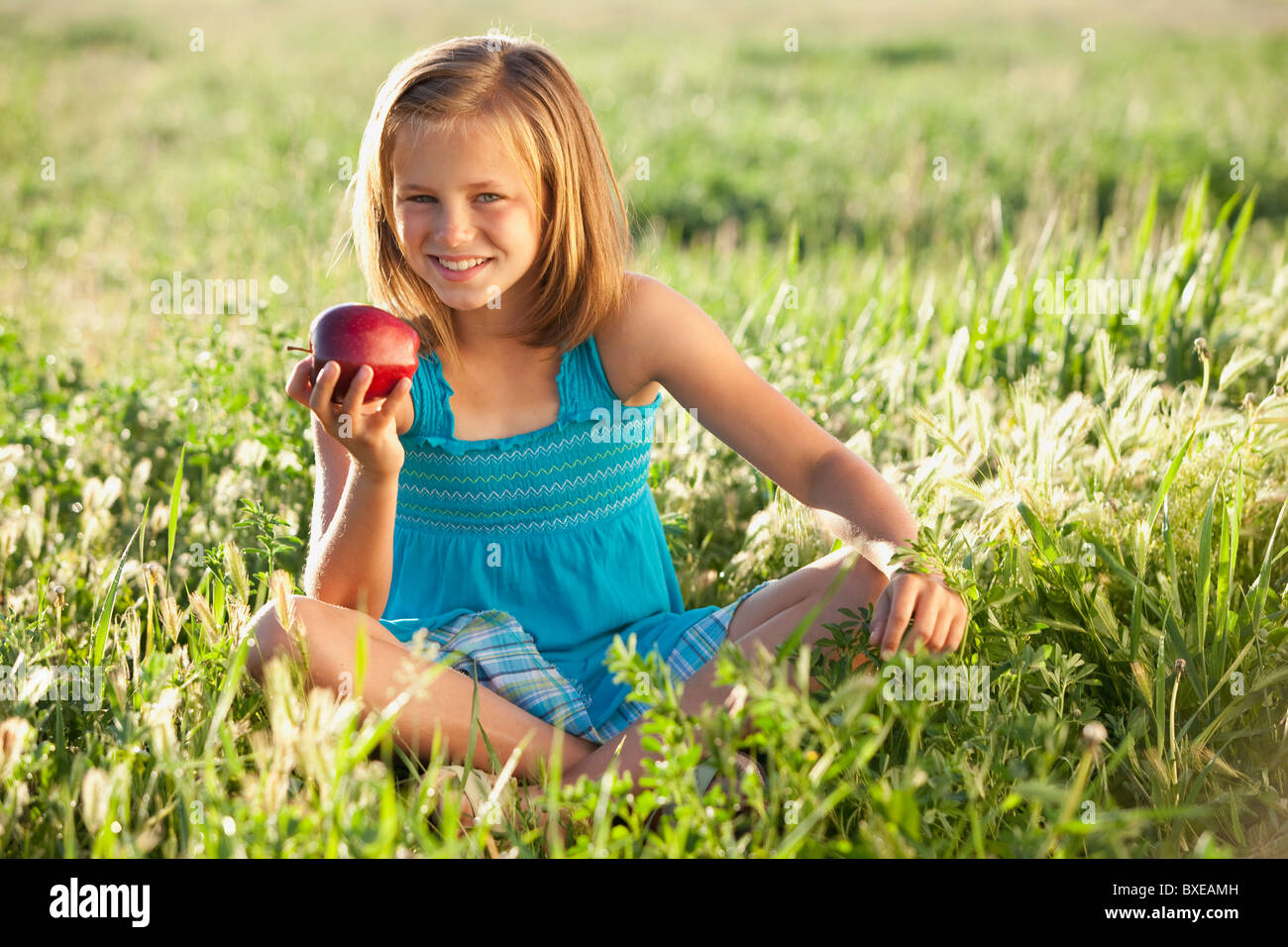 Young girl eating an apple Stock Photo