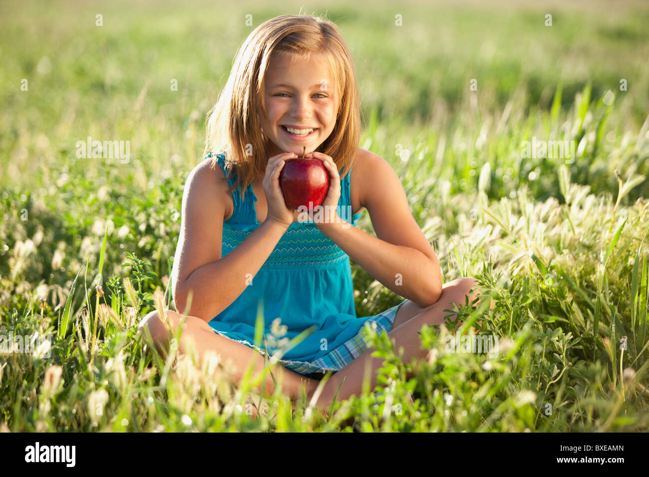 Young girl holding an apple Stock Photo