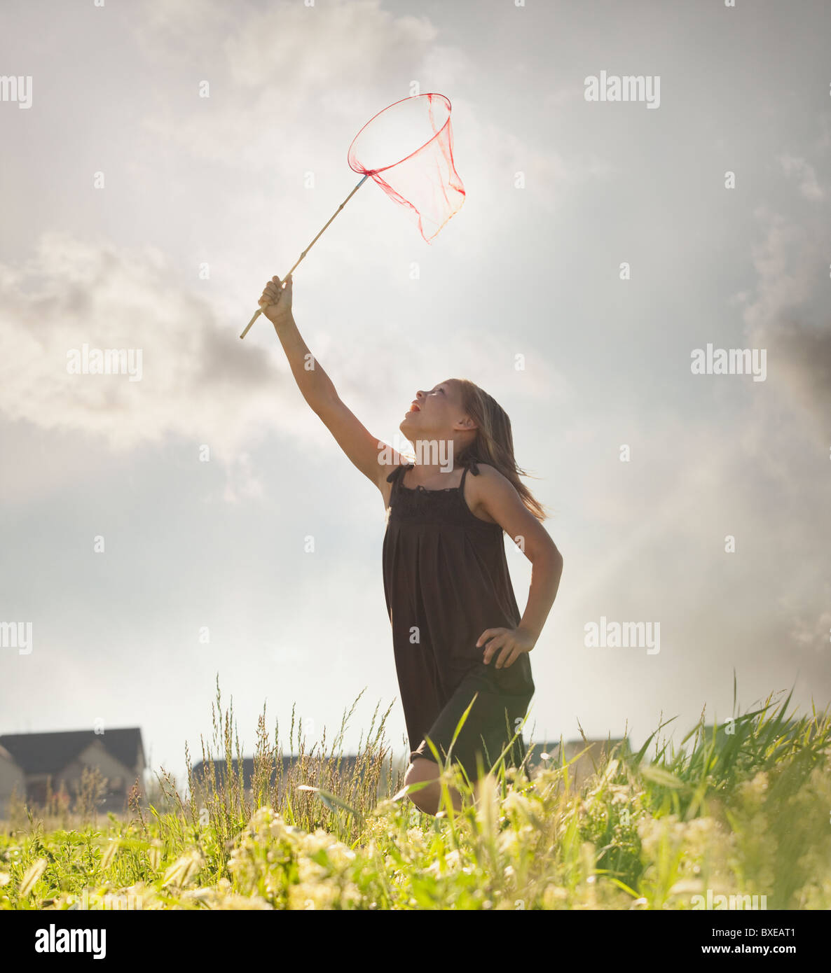 Young girl running with a butterfly net Stock Photo