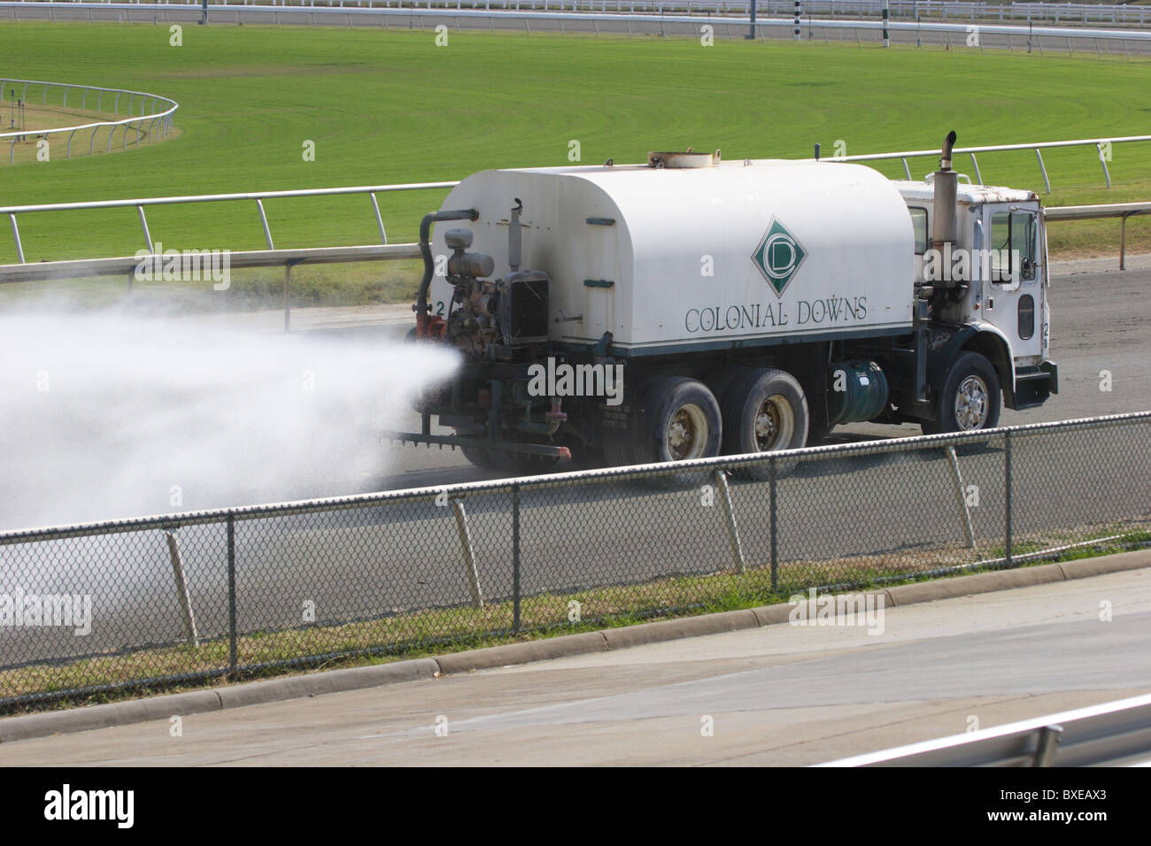 Water truck spraying horseracing track at Colonial Downs in New Kent County, Virginia. Stock Photo