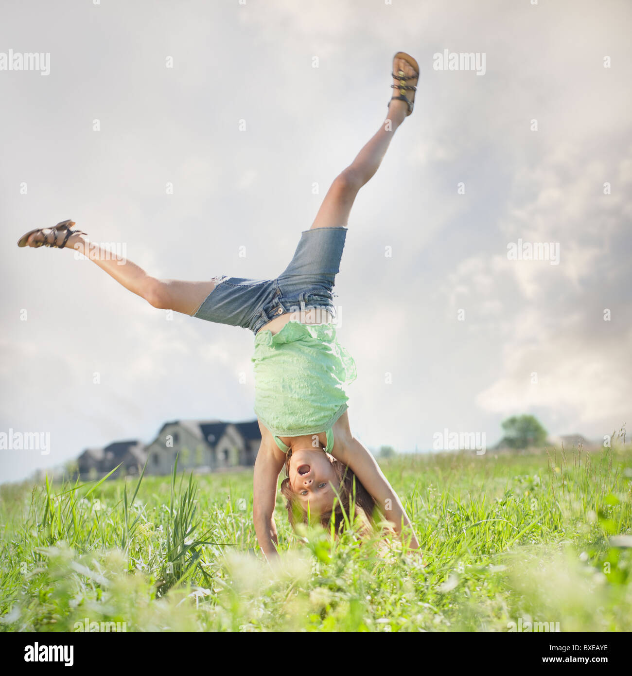 Young girl doing cartwheel Stock Photo Alamy