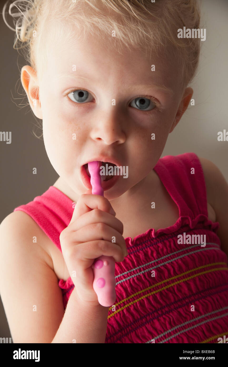 Cute young girl brushing her teeth Stock Photo