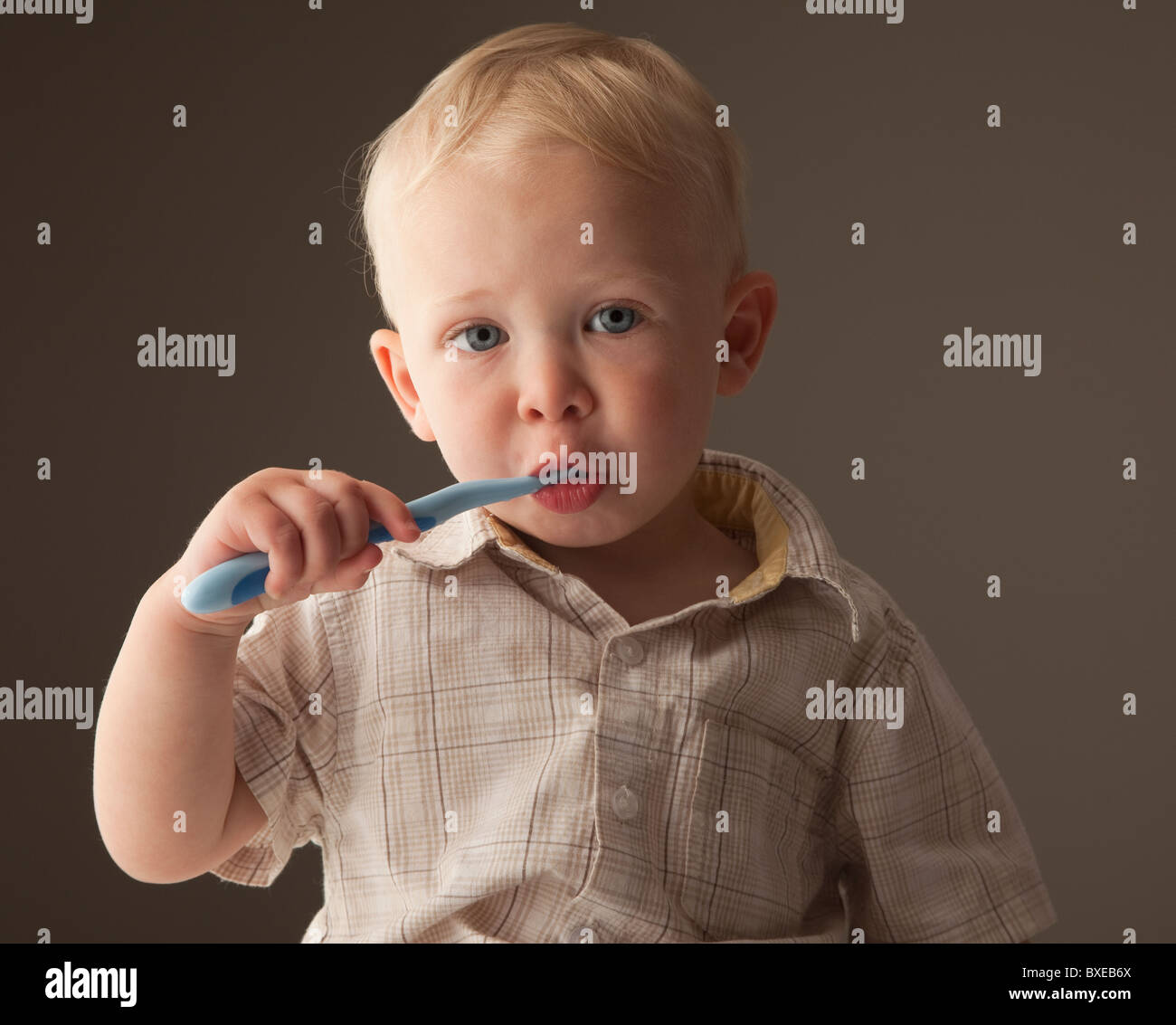Toddler brushing his teeth Stock Photo