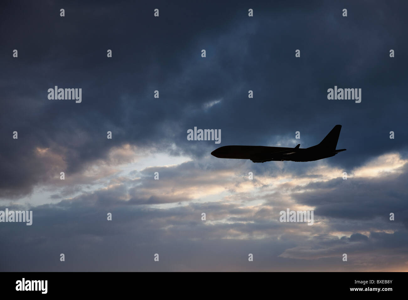 Commercial jet in cloudy sky Stock Photo