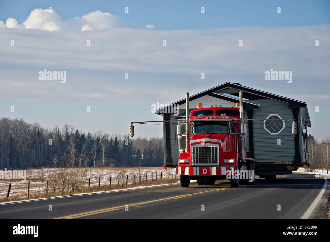 A red truck moving a house Stock Photo
