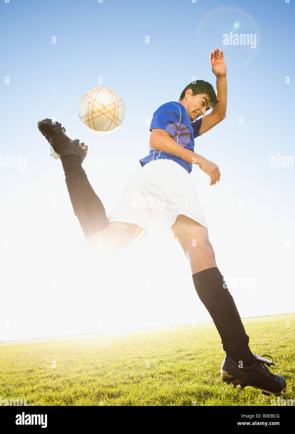 Soccer player jump kicking Stock Photo Alamy