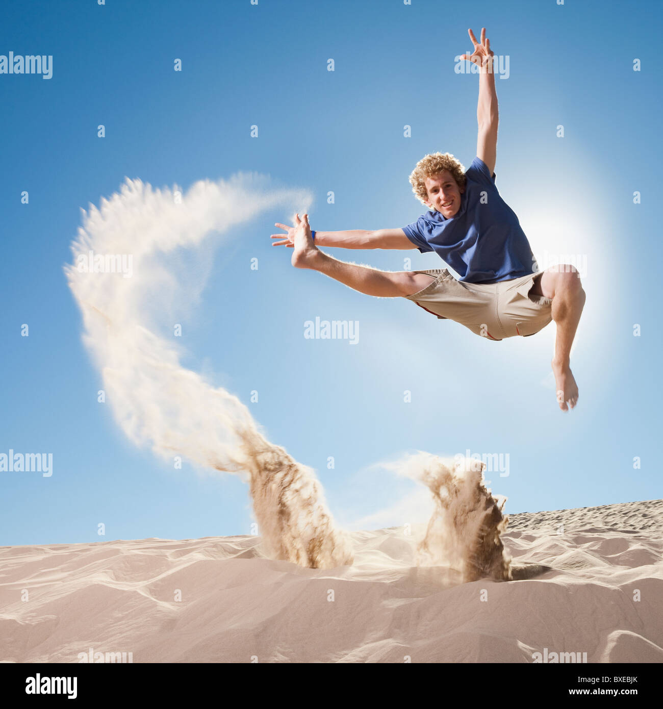 Energetic man jumping in the sand Stock Photo Alamy