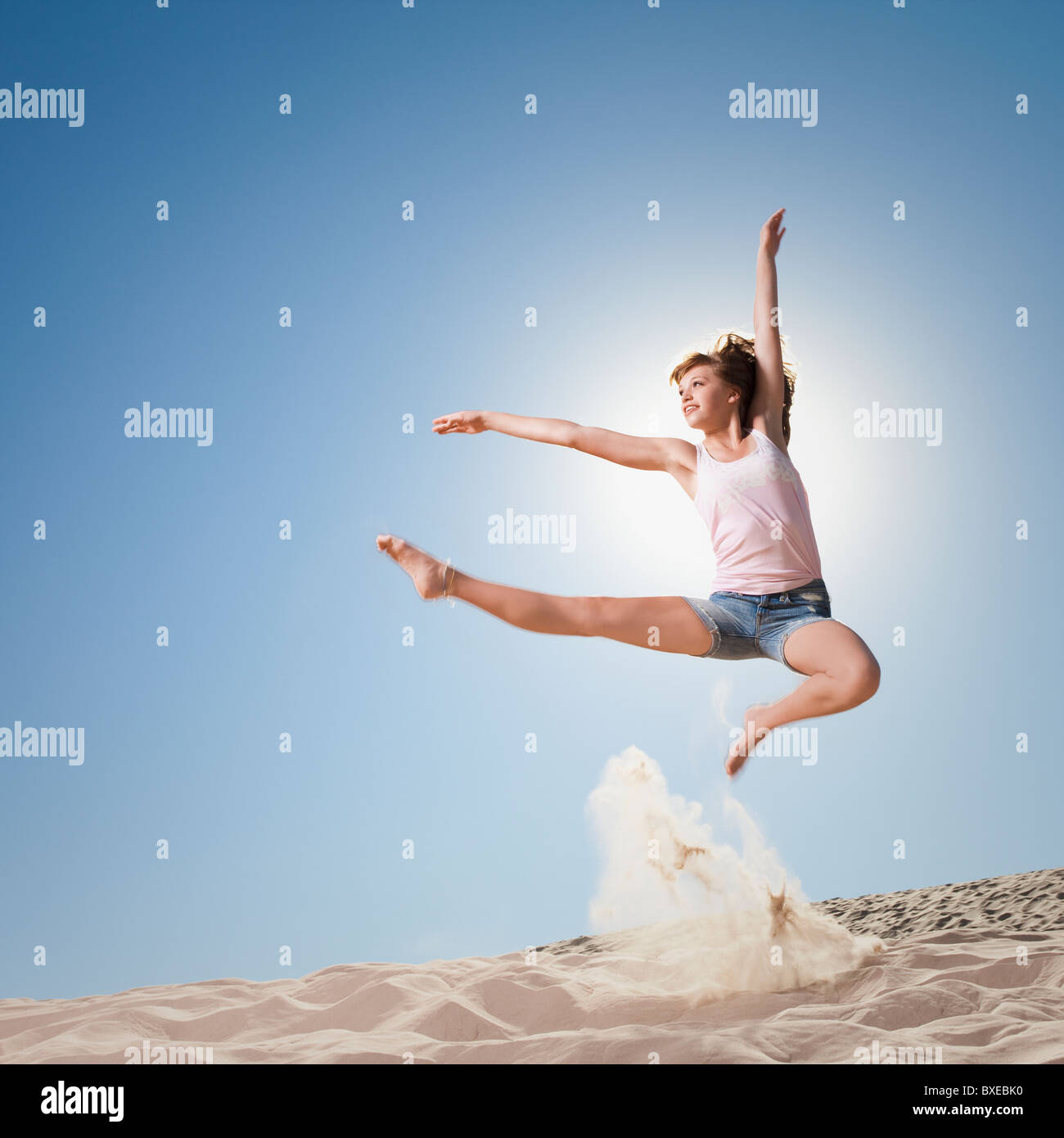 Female dancer jumping in sand Stock Photo Alamy