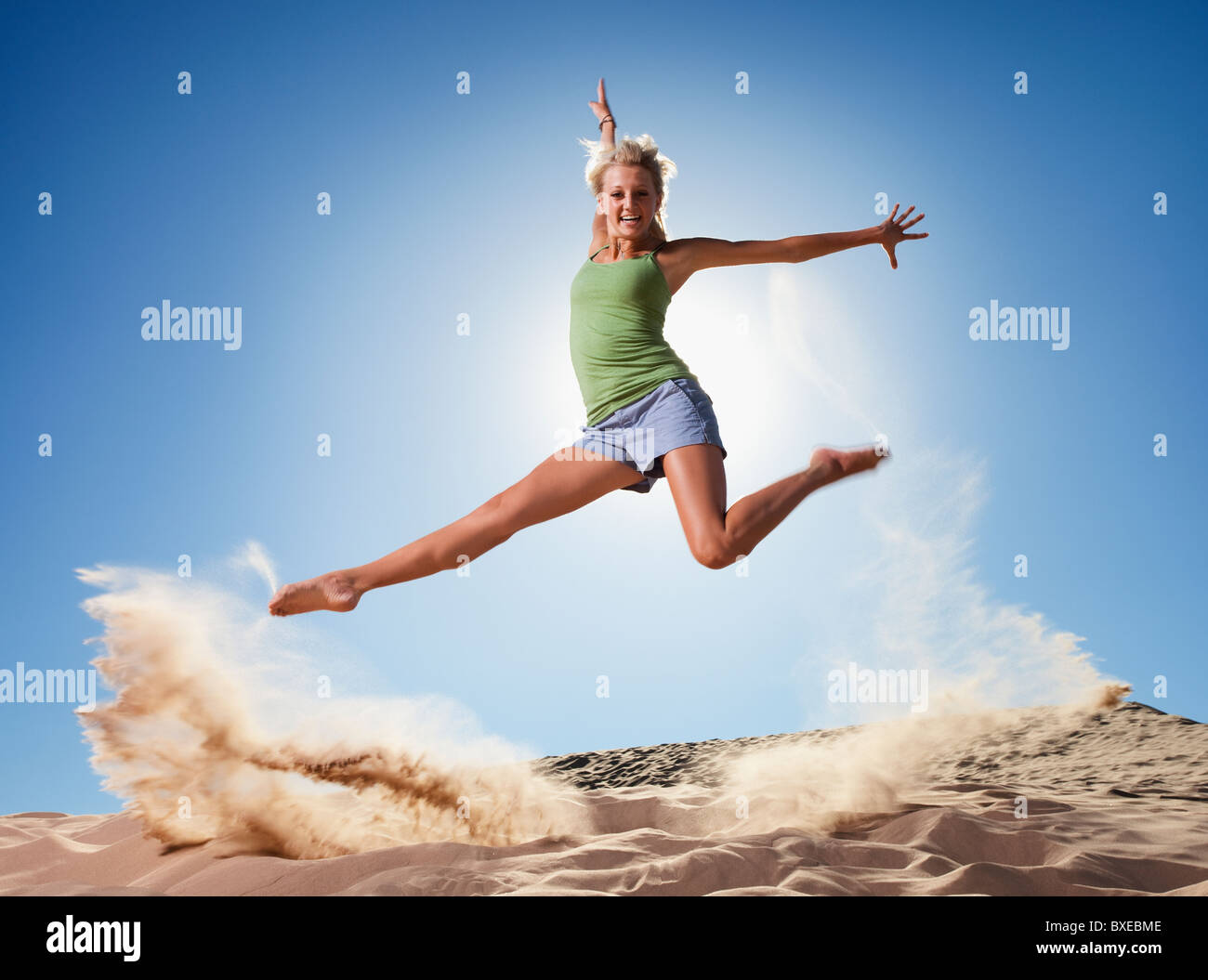 Female dancer jumping in sand Stock Photo Alamy