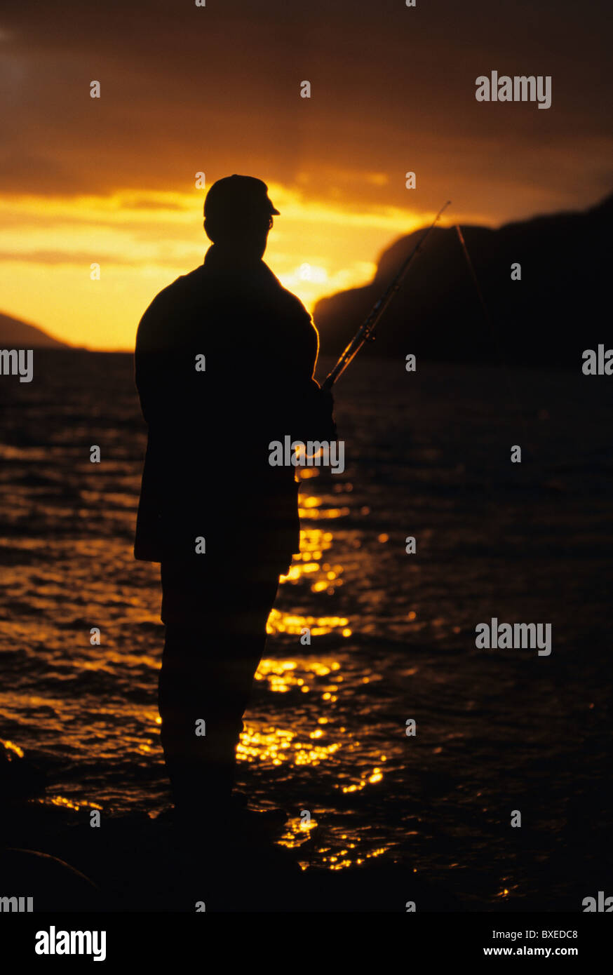 Man fishing in the sunset, fishing rod, sea, silhouette Stock Photo - Alamy