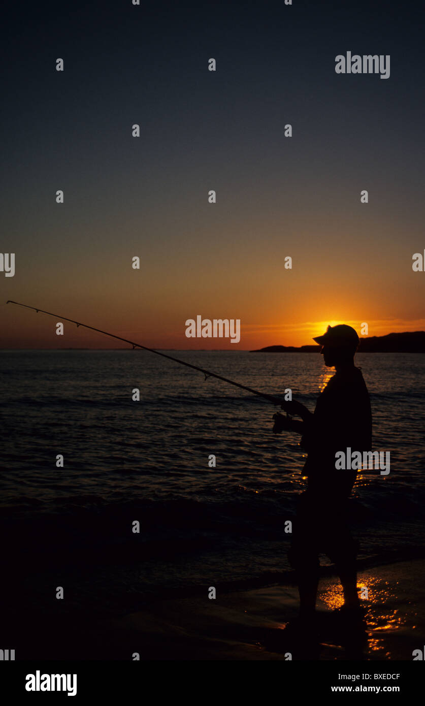 Man fishing in the sunset, fishing rod, sea, silhouette Stock Photo - Alamy