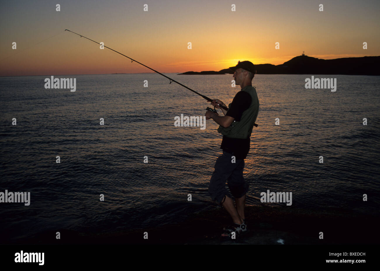 Man fishing in the sunset, fishing rod, sea, silhouette Stock Photo - Alamy