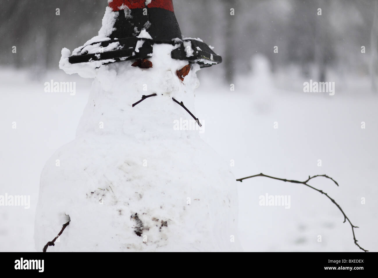 ugly and nervous snowman with western style hat Stock Photo