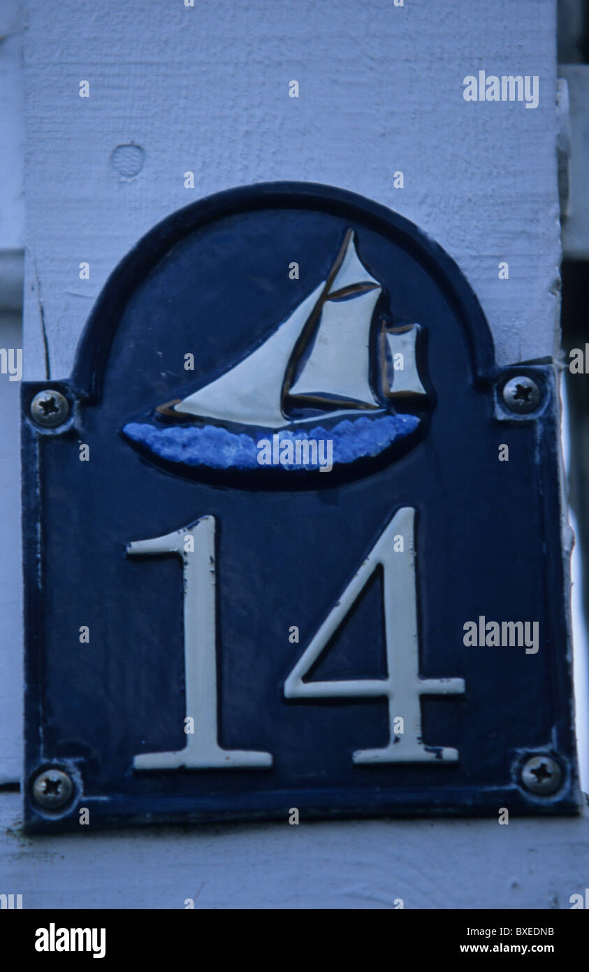 Number 14, house number with a boat, blue sign with a boat and number 14 Stock Photo