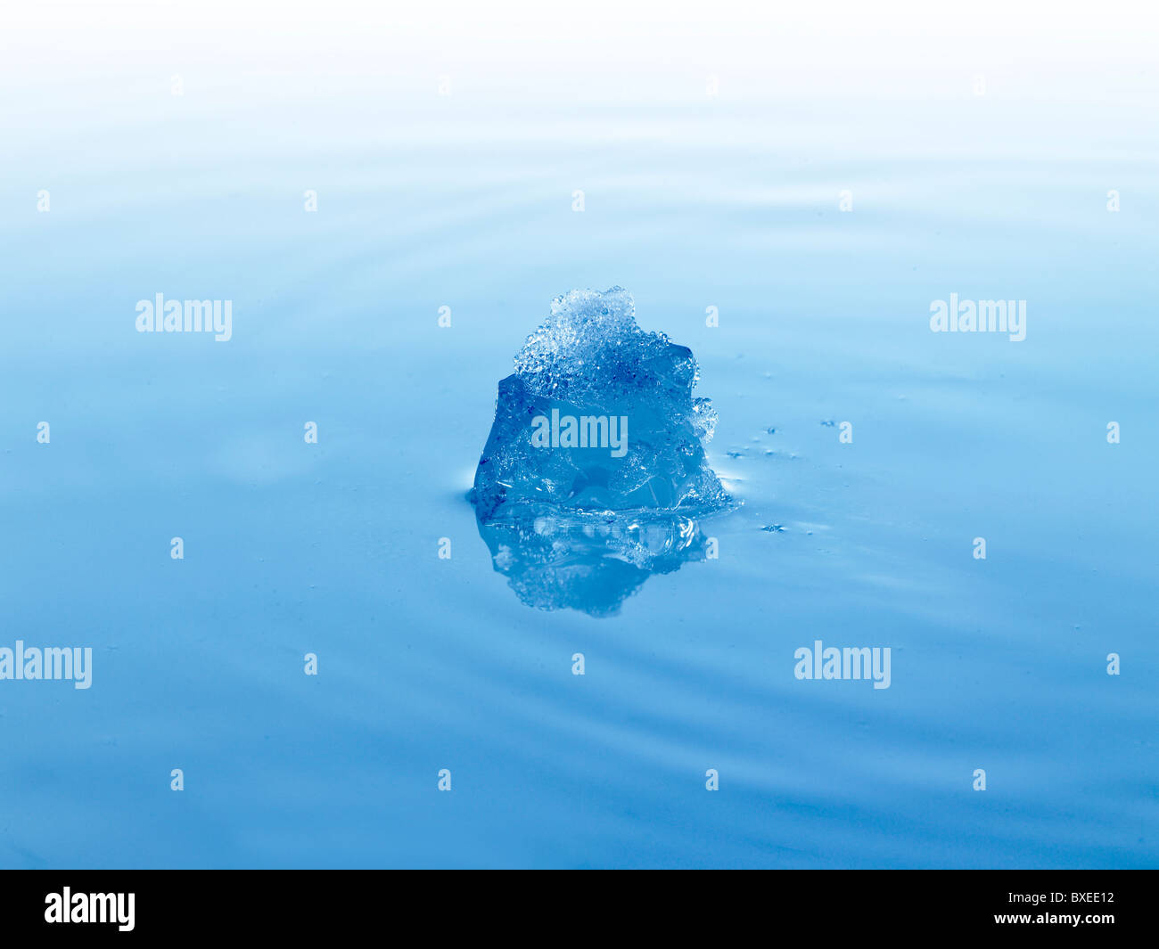 Ice cube in water Stock Photo