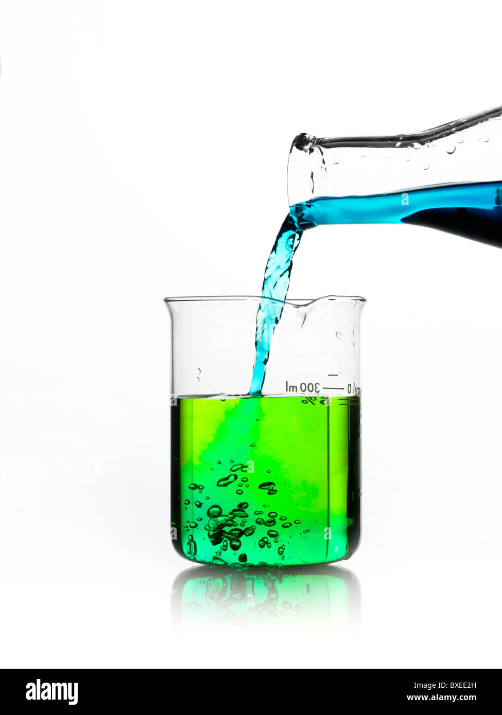 Blue liquid being poured into measuring cup Stock Photo