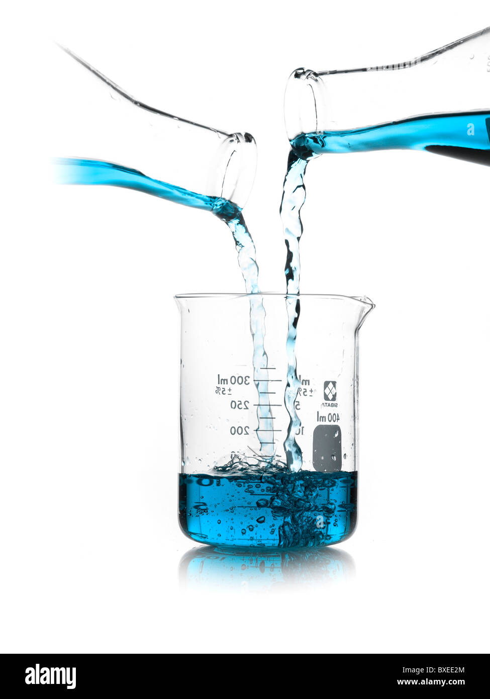Blue liquid being poured into measuring cup Stock Photo Alamy