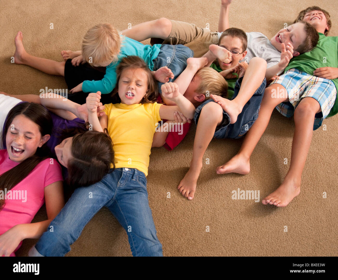 Group of children playing on floor Stock Photo