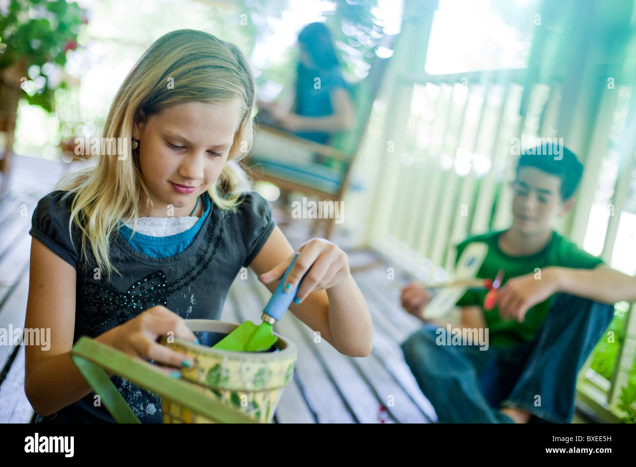 Young girl potting a plant Stock Photo - Alamy