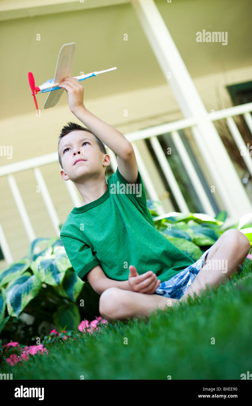 Young boy playing with toy airplane Stock Photo - Alamy