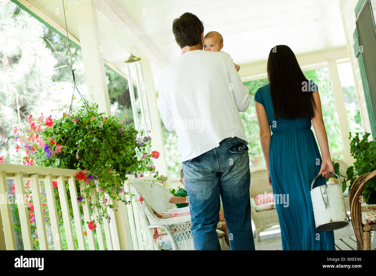 Young family walking on porch Stock Photo