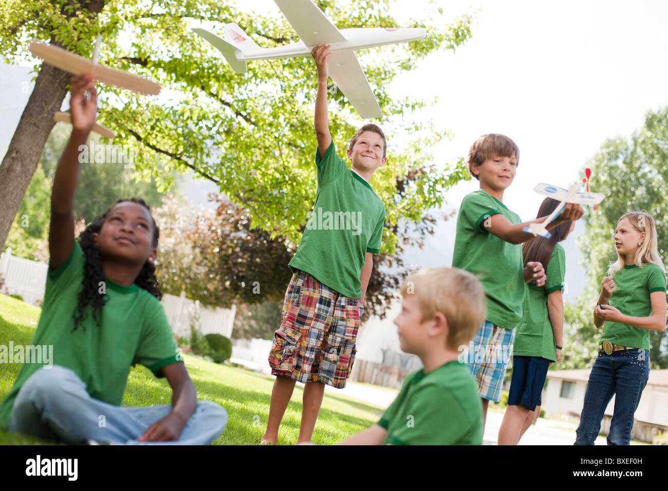 Group of children playing with toy airplanes Stock Photo