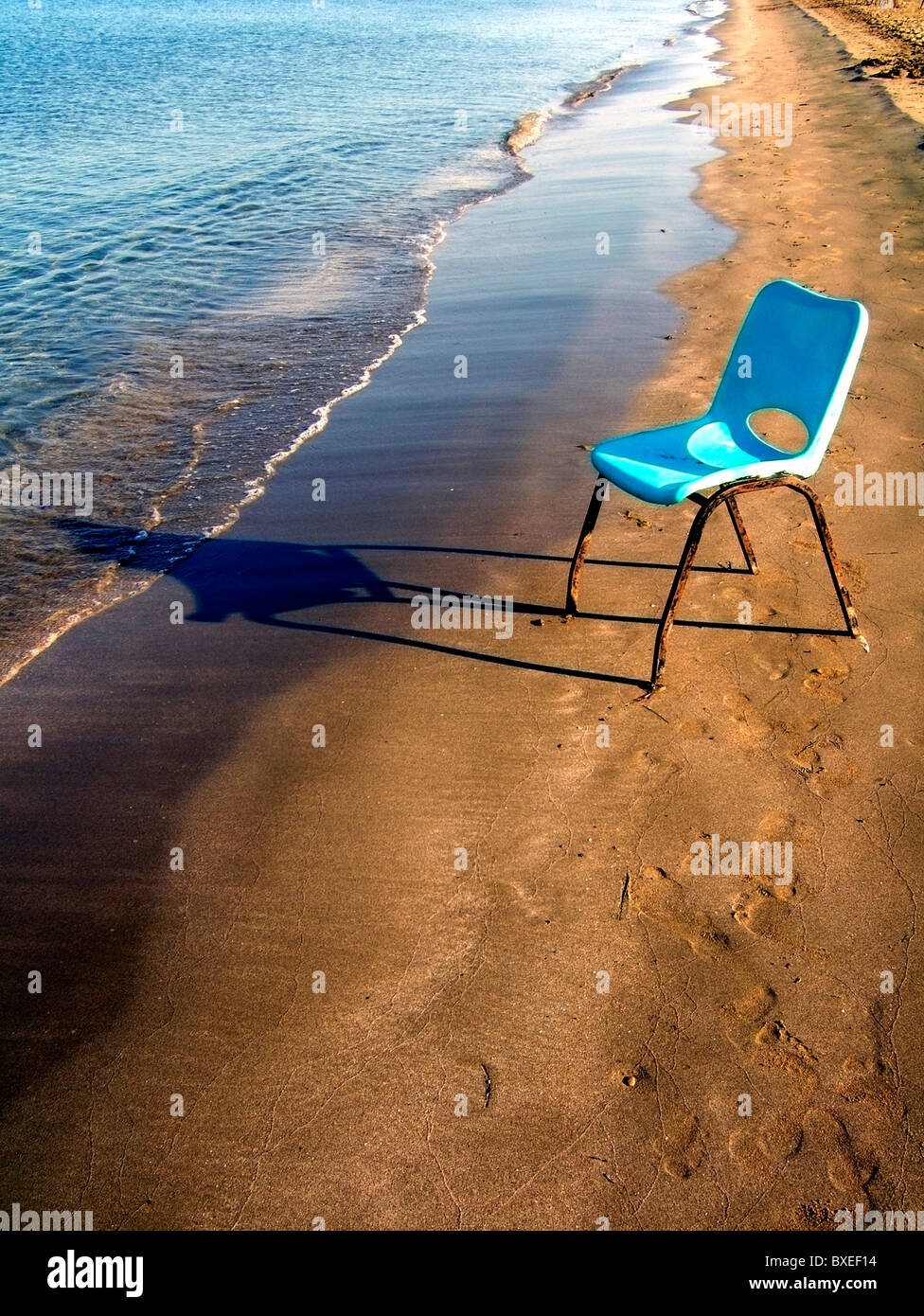 Cheap Mass Produced Chair Casting Shadow Beside Sea On Sandy Beach At Lady S Mile Cyprus Stock Photo Alamy