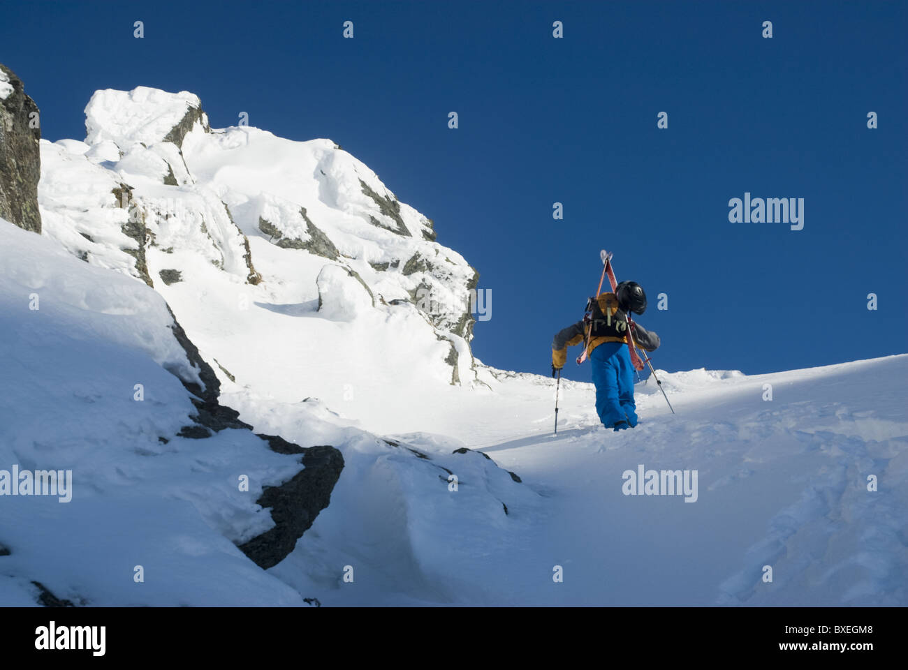 A free skier climbing up a snowy mountain side near Narvik, Norway Stock Photo