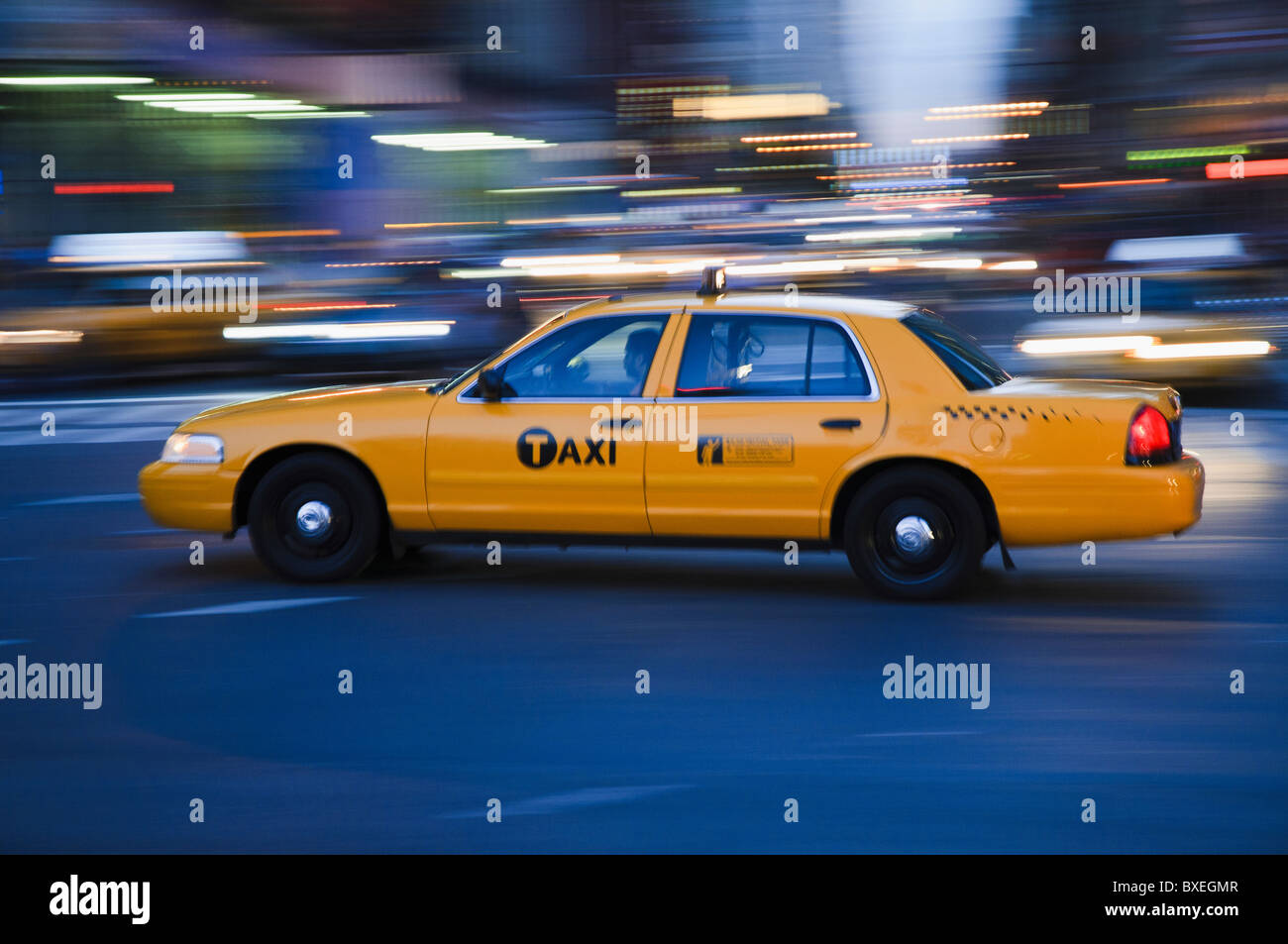 Taxi cab driving in the evening Stock Photo