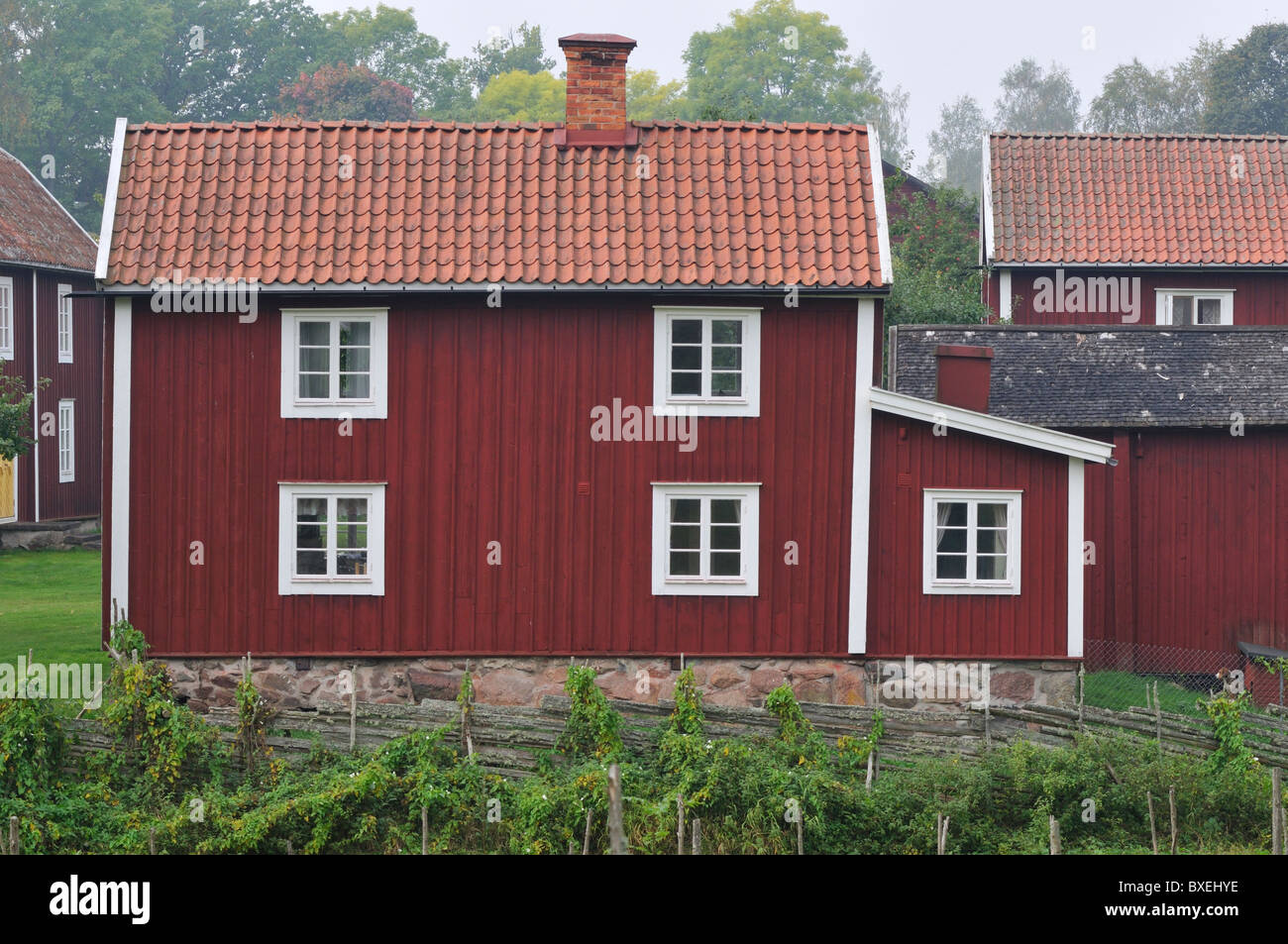 Traditional old red wooden house with white corners and windows i Stensjo village Stock Photo