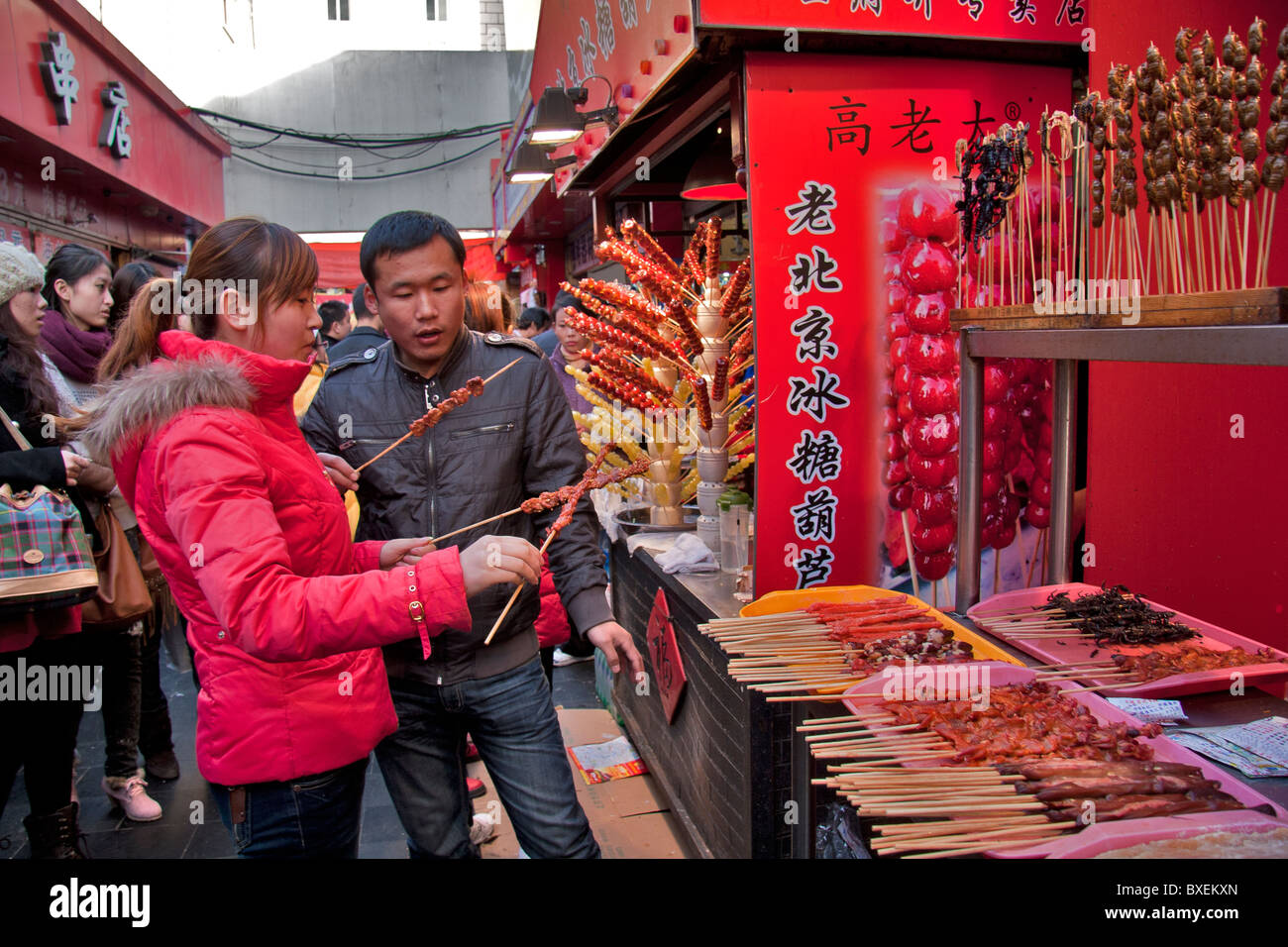 People eating at food market in Wangfujing street, Beijing, China Stock Photo