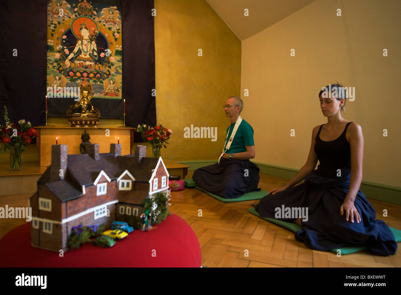Buddhists meditate in silence for 30 minutes in their Shrine Room at the Rivendell Buddhist Retreat Centre, England. Stock Photo