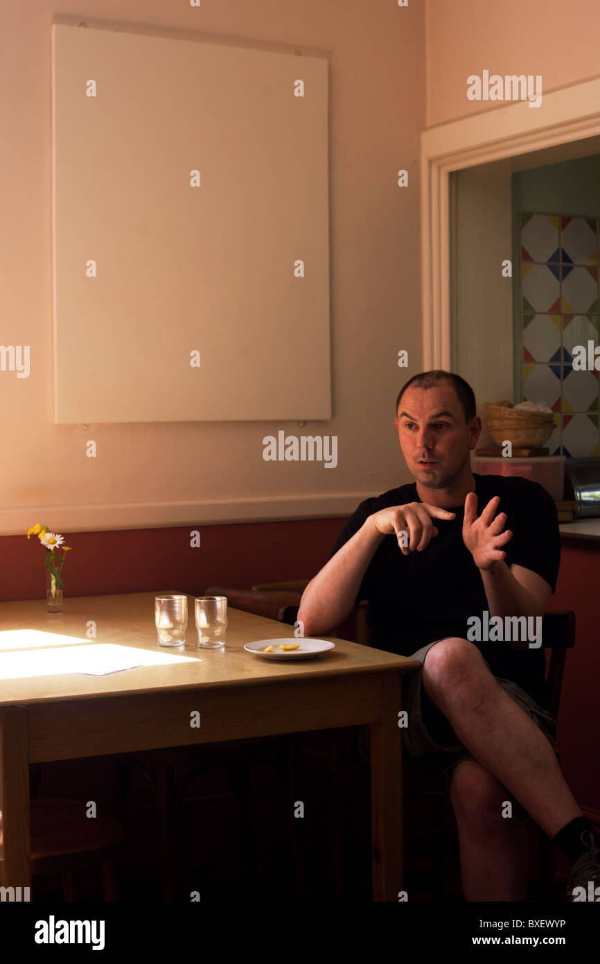 After meal talk for the Buddhist monk Nagasiddhi in dining room at the Rivendell Buddhist Retreat Centre, England. Stock Photo